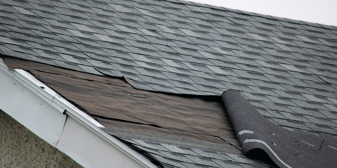 Damaged and torn roof shingles 